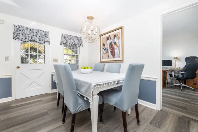 a view of a dining room with furniture and wooden floor