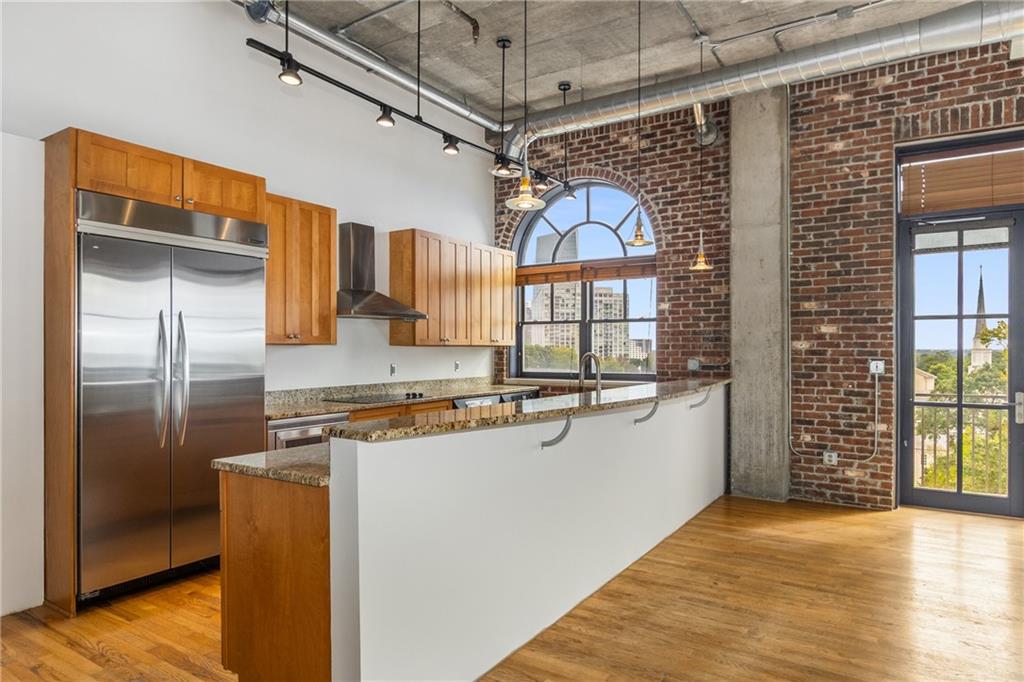 3180 Mathieson Drive Northeast, Unit 1010 Atlanta, GA 30305 - Photo 12 of 44 a kitchen with stainless steel appliances granite countertop a refrigerator a sink and a stove
