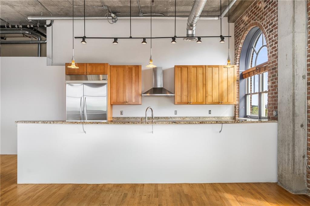 3180 Mathieson Drive Northeast, Unit 1010 Atlanta, GA 30305 - Photo 13 of 44 a kitchen with stainless steel appliances granite countertop a sink and a white cabinets
