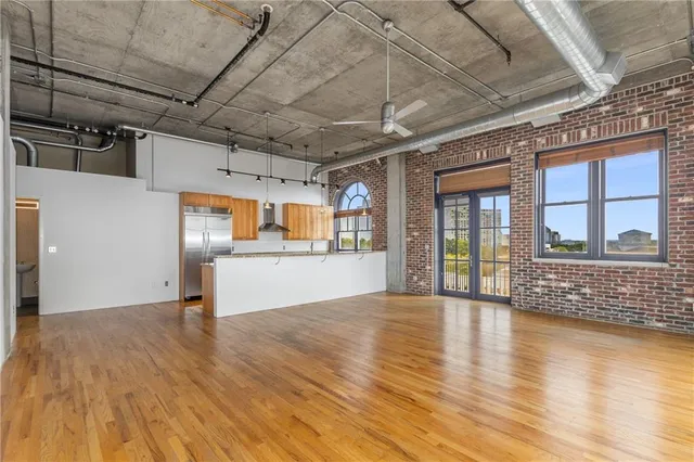 a kitchen with stainless steel appliances granite countertop a sink and a refrigerator