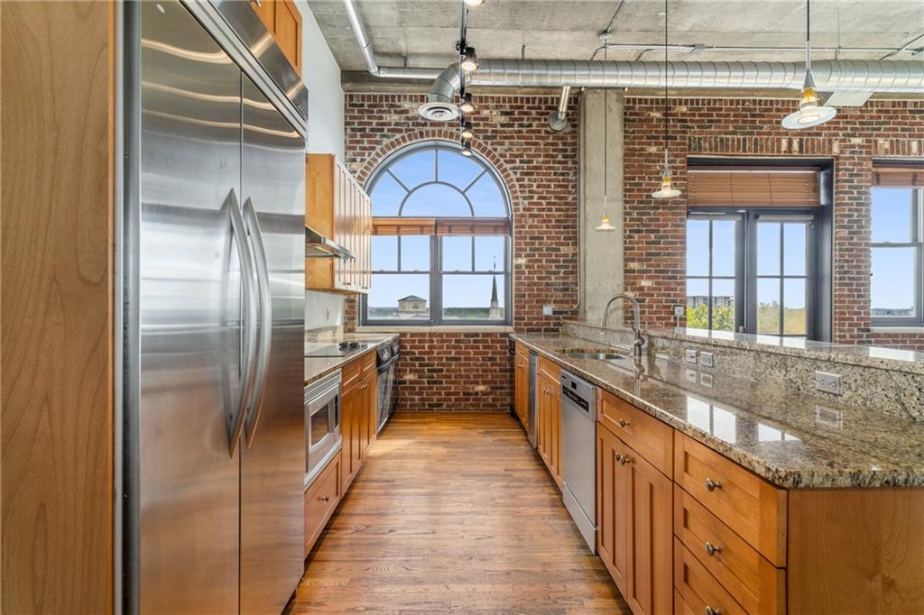 3180 Mathieson Drive Northeast, Unit 1010 Atlanta, GA 30305 - Photo 16 of 44 a kitchen with stainless steel appliances granite countertop a sink and a refrigerator