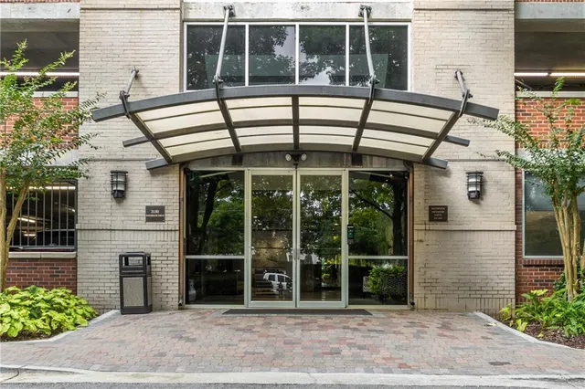 a lobby with furniture and a potted plant