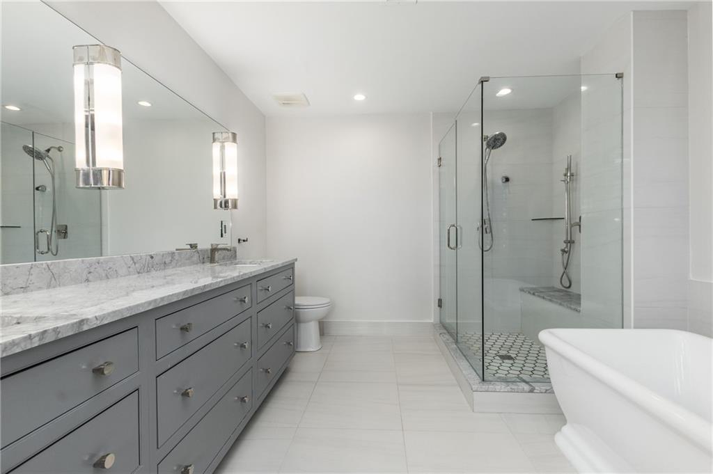 3180 Mathieson Drive Northeast, Unit 1010 Atlanta, GA 30305 - Photo 23 of 44 a bathroom with a double vanity sink toilet and shower