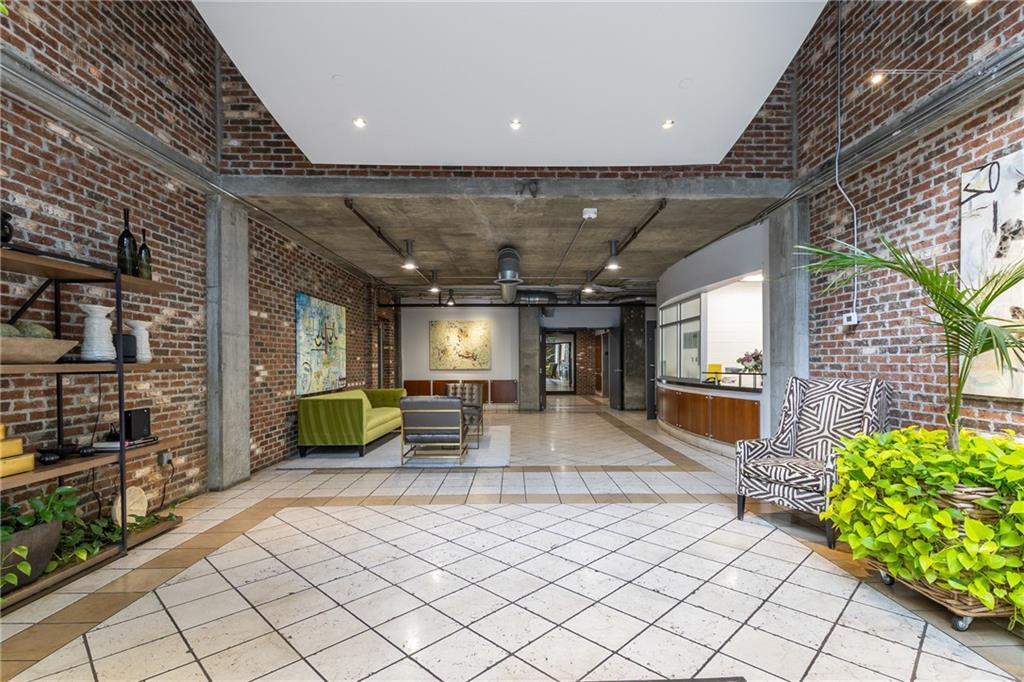 3180 Mathieson Drive Northeast, Unit 1010 Atlanta, GA 30305 - Photo 3 of 44 a lobby with furniture and a potted plant