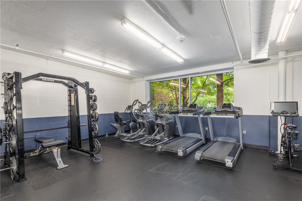 3180 Mathieson Drive Northeast, Unit 1010 Atlanta, GA 30305 - Photo 33 of 44 a room with gym equipment and a large window