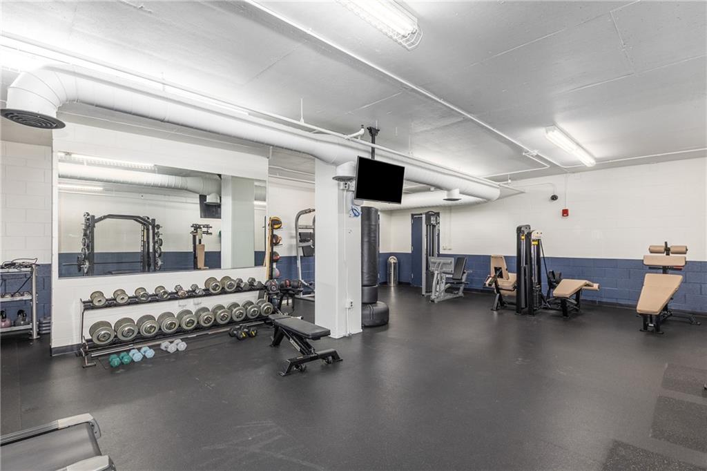 3180 Mathieson Drive Northeast, Unit 1010 Atlanta, GA 30305 - Photo 34 of 44 a bedroom with furniture and a large window