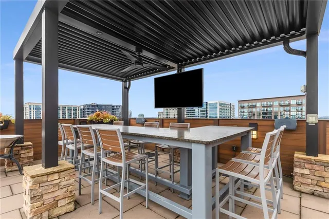 a view of a patio with a dining table and chairs with wooden floor