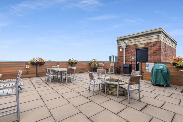 a view of a patio with dining table and chairs