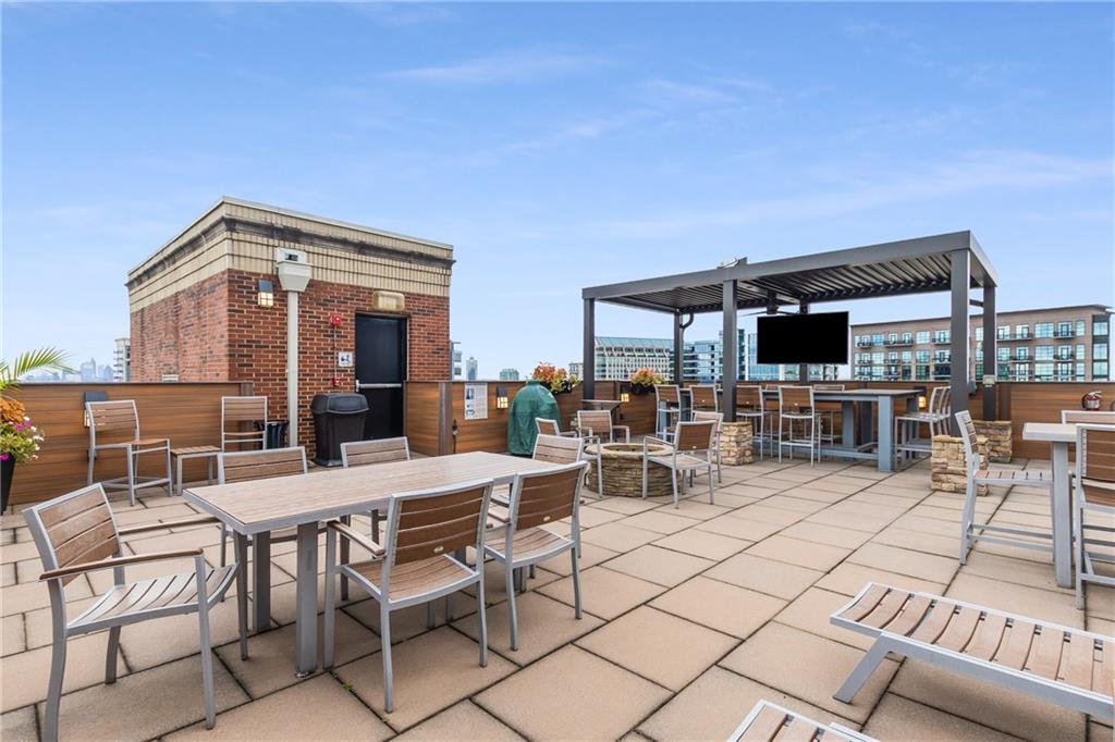 3180 Mathieson Drive Northeast, Unit 1010 Atlanta, GA 30305 - Photo 38 of 44 a view of a patio with a dining table and chairs with wooden floor