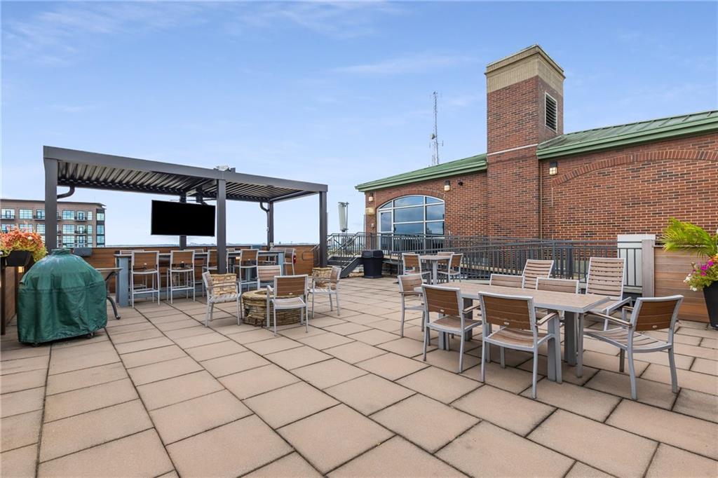 3180 Mathieson Drive Northeast, Unit 1010 Atlanta, GA 30305 - Photo 39 of 44 a view of a patio with dining table and chairs