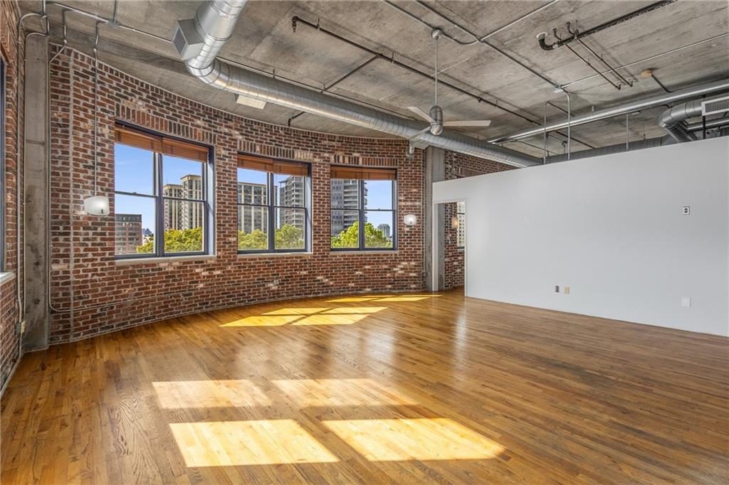 3180 Mathieson Drive Northeast, Unit 1010 Atlanta, GA 30305 - Photo 7 of 44 a view of an empty room with wooden floor and a window