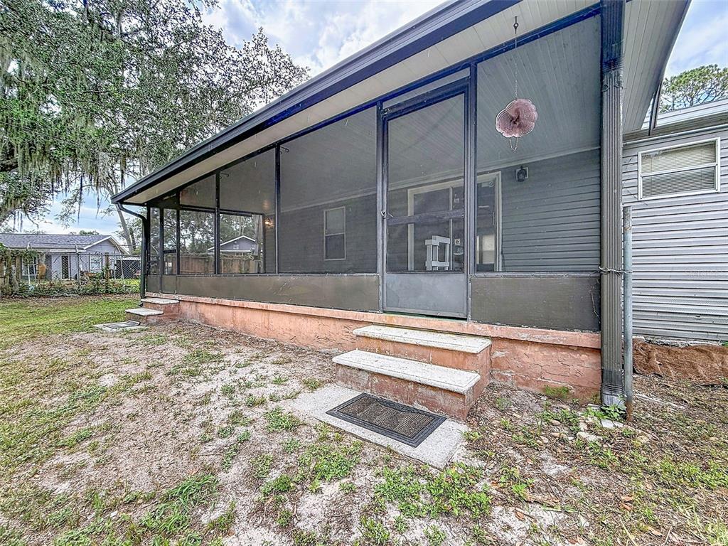 1819 Sinclair Hills Road Lutz, FL 33549 - Photo 13 of 60 a front view of a house with a yard