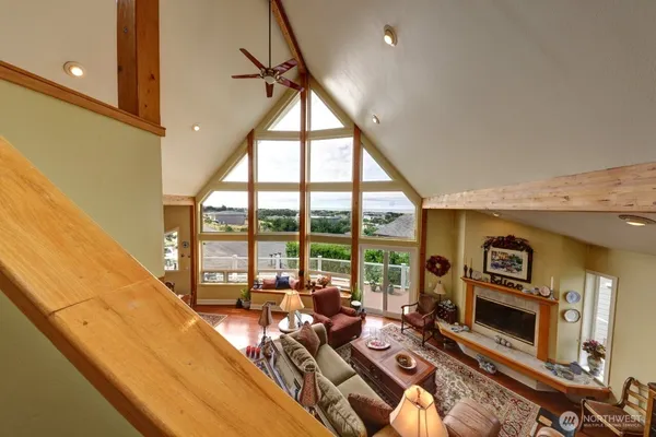 a living room with fireplace furniture and a large window