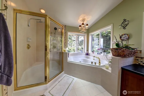 a view of a bathroom with a tub shower and mirror