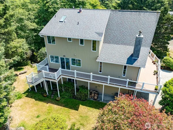an aerial view of a house with swimming pool and sitting area