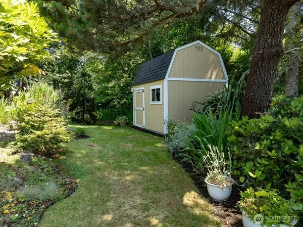 a view of backyard with plants and a garden