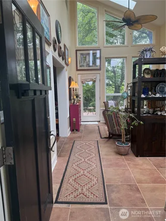 a living room with furniture a fireplace and a large window