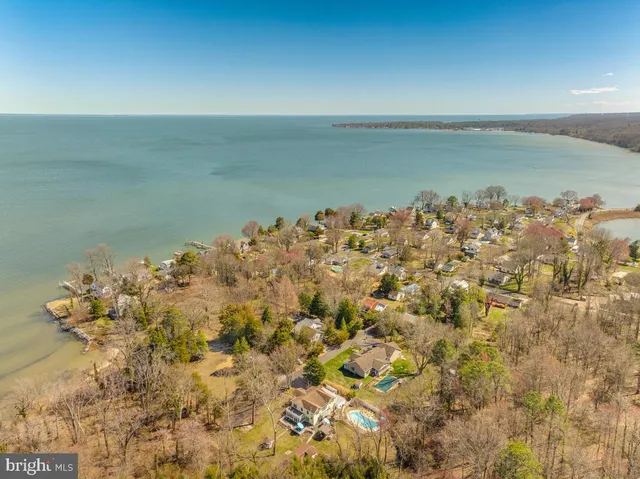a view of yard covered with snow in front of house