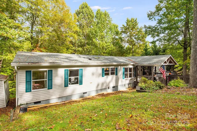 a backyard of a house with yard and outdoor seating