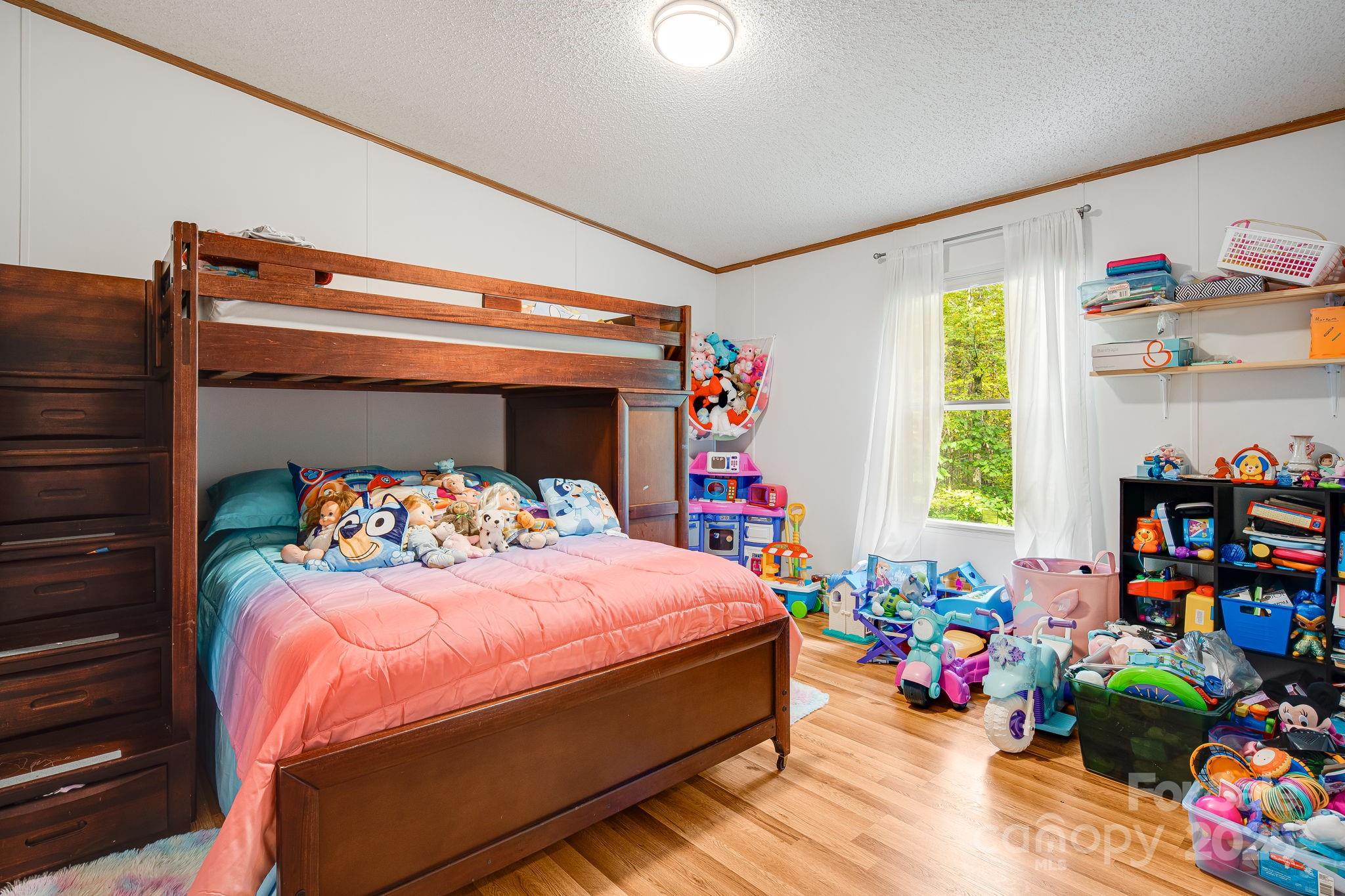 52 Rocky Cove Road Candler, NC 28715 - Photo 13 of 17 a bedroom with a bed and a window