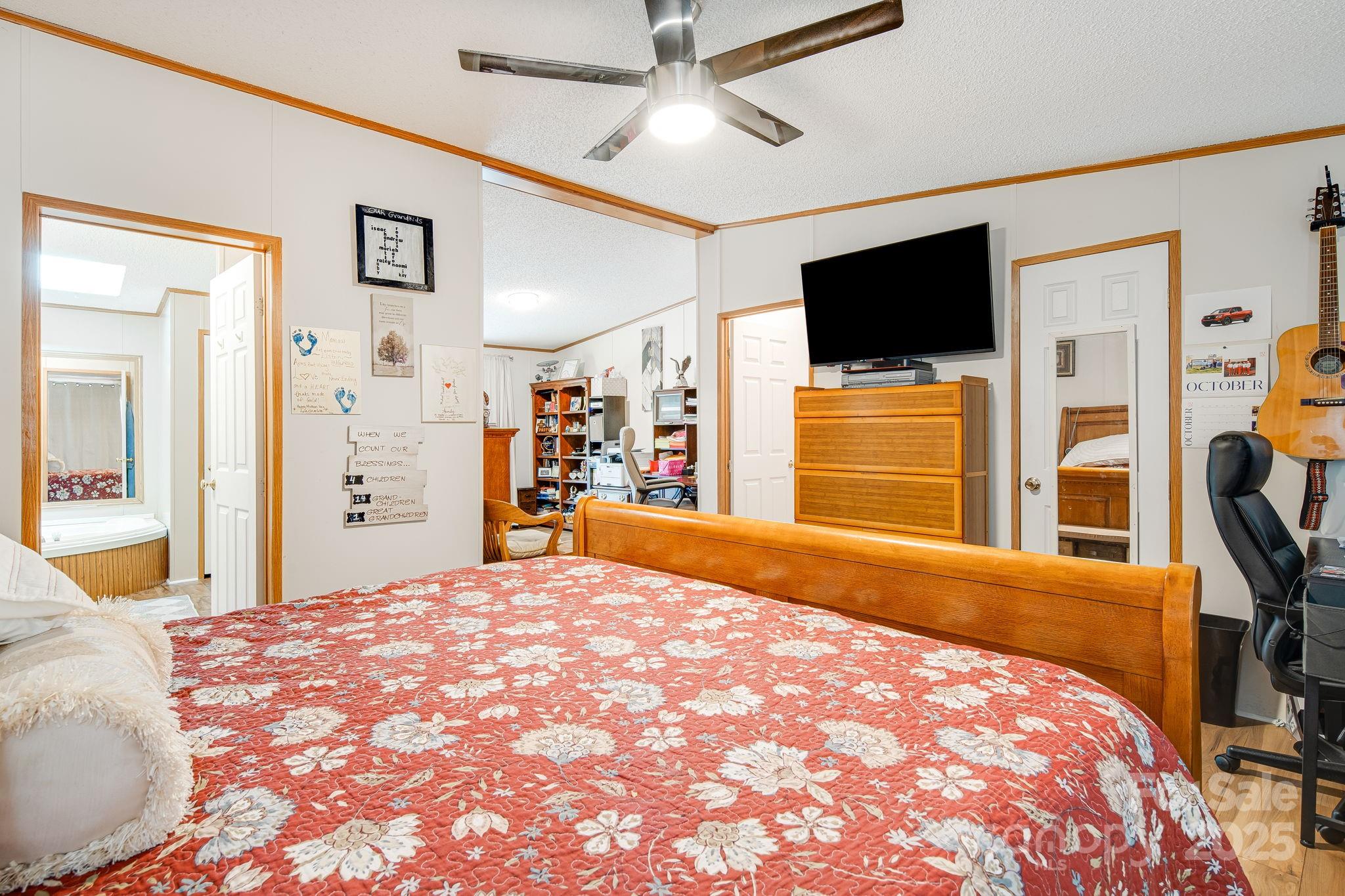 52 Rocky Cove Road Candler, NC 28715 - Photo 8 of 17 a bedroom with a bed and a flat screen tv