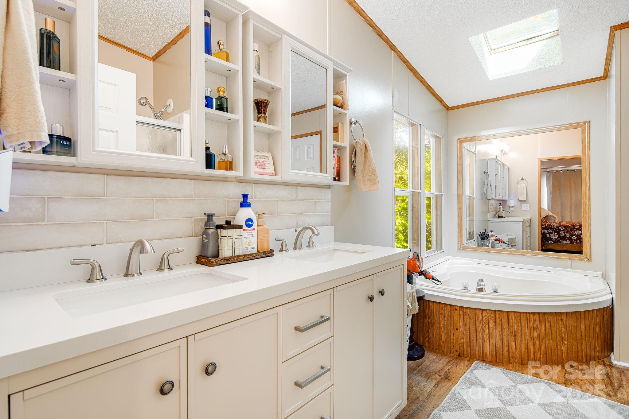 52 Rocky Cove Road Candler, NC 28715 - Photo 9 of 17 a bathroom with a tub sink and mirror