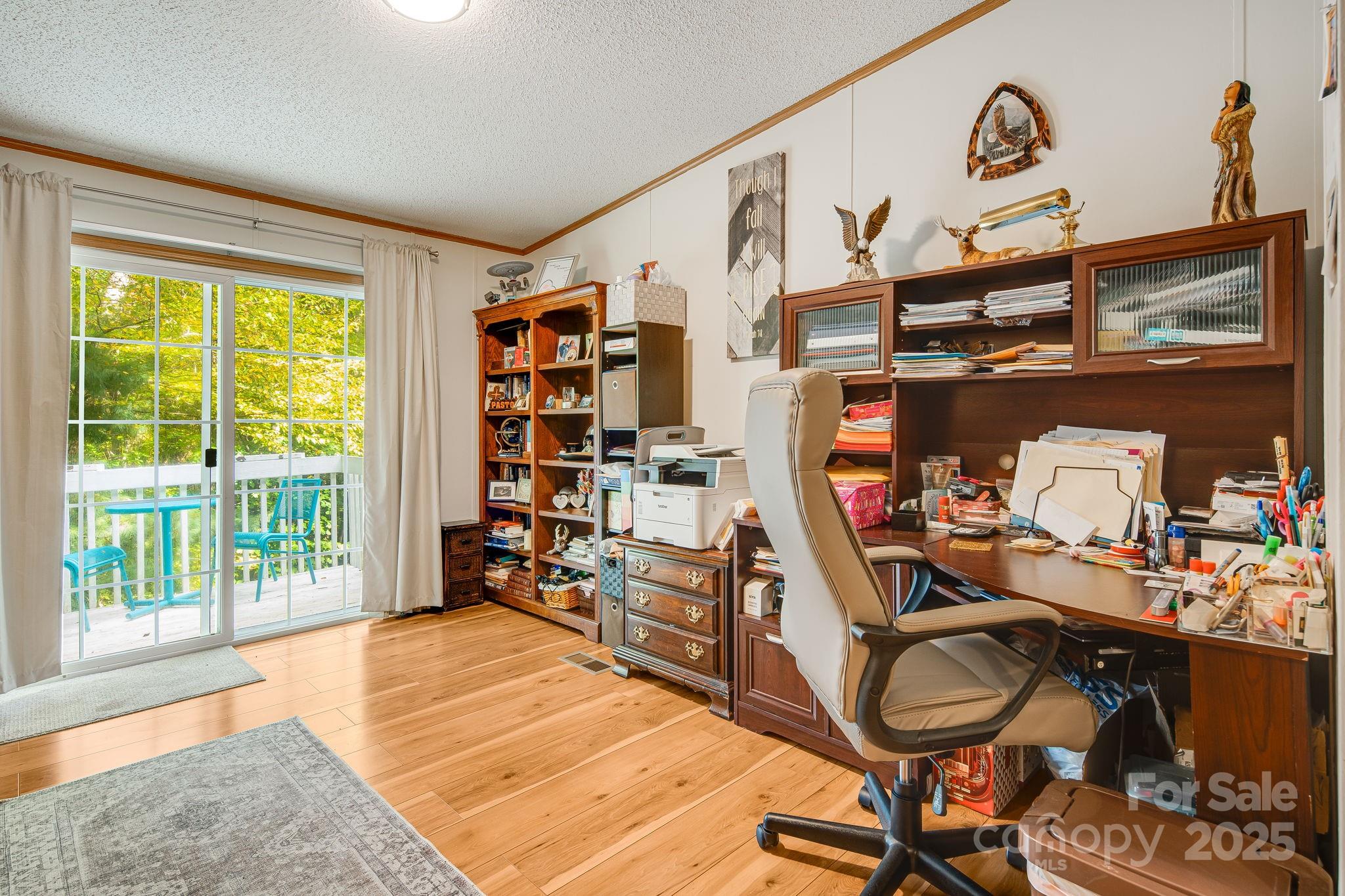 52 Rocky Cove Road Candler, NC 28715 - Photo 10 of 17 a room with furniture and a book shelf
