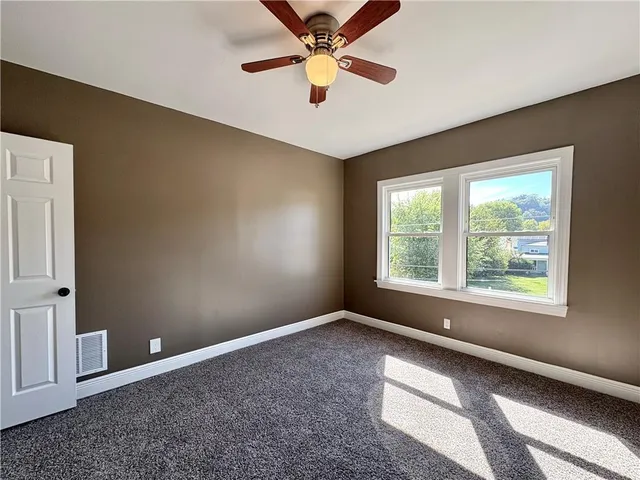 a view of room with window and ceiling fan