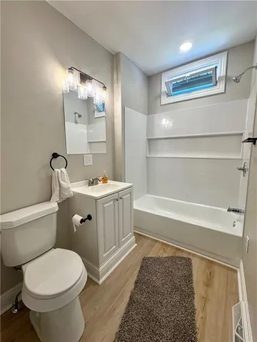 a bathroom with a toilet a sink and bathtub