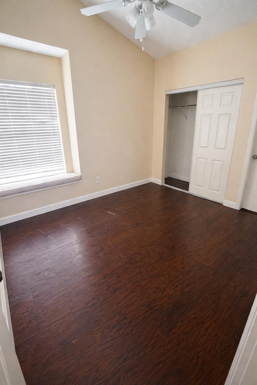 5302 Sapphire Valley Boca Raton, FL 33431 - Photo 9 of 13 an empty room with wooden floor cabinet and windows