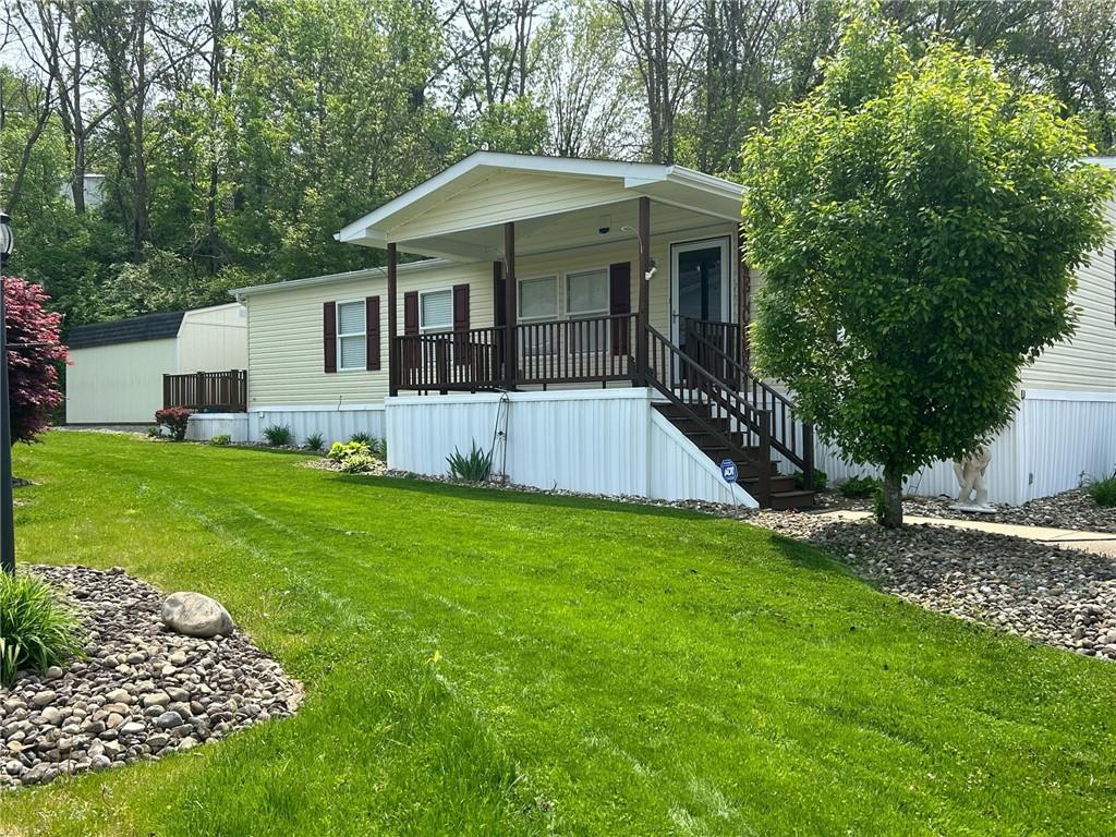 a view of house with backyard and garden