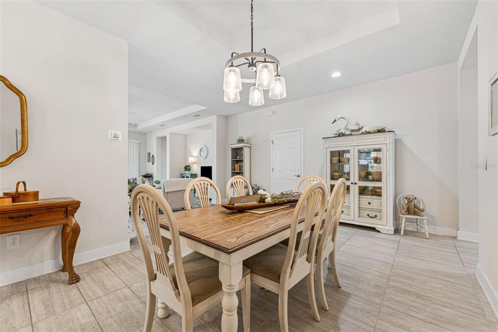 1237 Windy Bay Shoal Tarpon Springs, FL 34689 - Photo 12 of 44 a view of a dining room with furniture and wooden floor