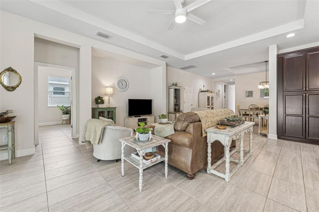 1237 Windy Bay Shoal Tarpon Springs, FL 34689 - Photo 14 of 44 a living room with furniture a fireplace and a flat screen tv