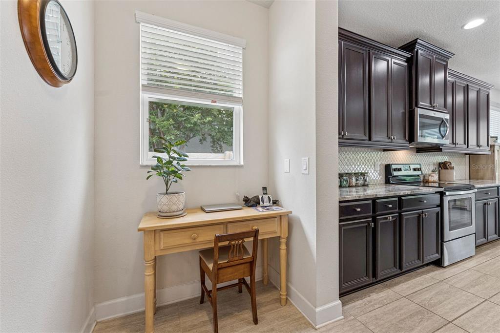 1237 Windy Bay Shoal Tarpon Springs, FL 34689 - Photo 21 of 44 a kitchen with stainless steel appliances a sink and a refrigerator