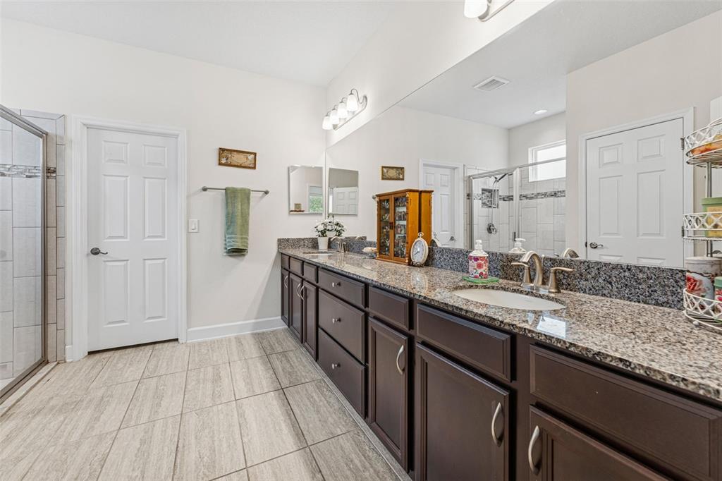 1237 Windy Bay Shoal Tarpon Springs, FL 34689 - Photo 23 of 44 a bathroom with a sink double vanity granite and a shower