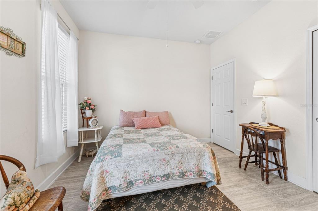 1237 Windy Bay Shoal Tarpon Springs, FL 34689 - Photo 27 of 44 a bedroom with a bed and wooden floor