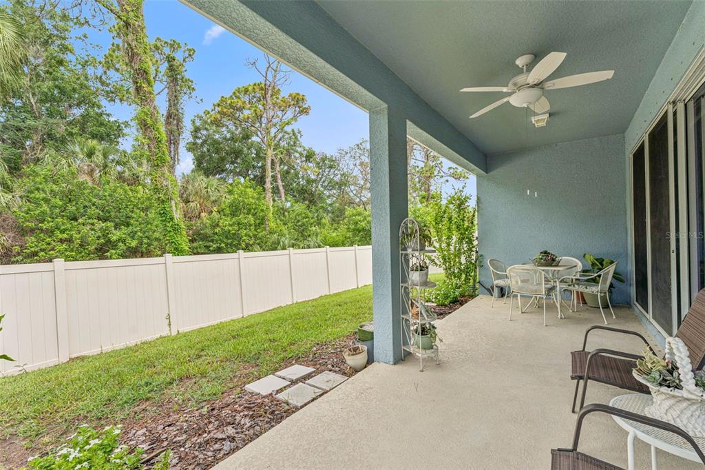 1237 Windy Bay Shoal Tarpon Springs, FL 34689 - Photo 34 of 44 a view of a porch with chairs and backyard