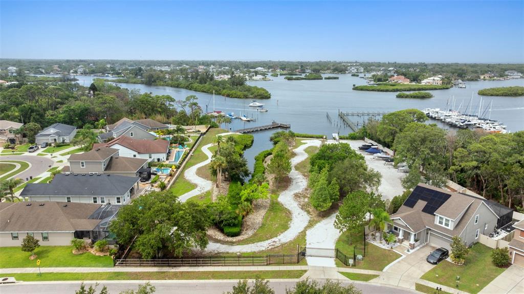 1237 Windy Bay Shoal Tarpon Springs, FL 34689 - Photo 42 of 44 an aerial view of residential building with outdoor space and lake view