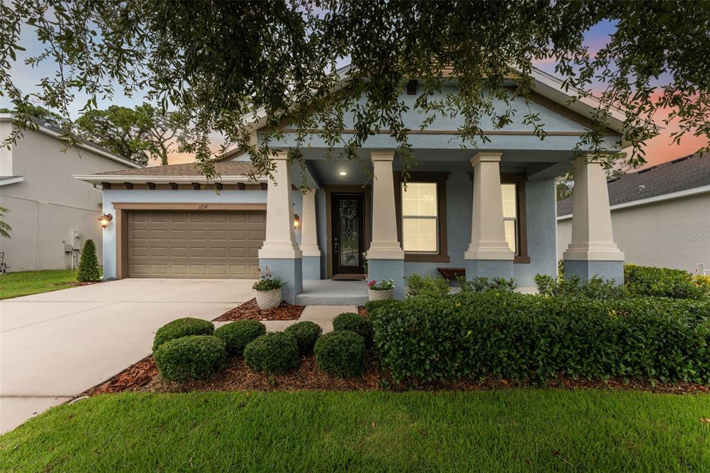 1237 Windy Bay Shoal Tarpon Springs, FL 34689 - Photo 6 of 44 a front view of a house with garden
