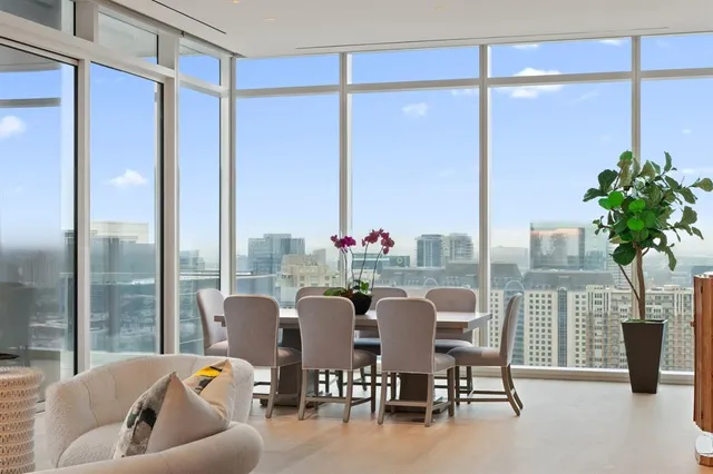 a dining room with furniture and a potted plant
