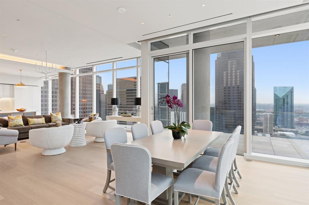 1747 Leonard Street, Unit 2402 Dallas, TX 75201 - Photo 2 of 35 a dining room with furniture and a potted plant