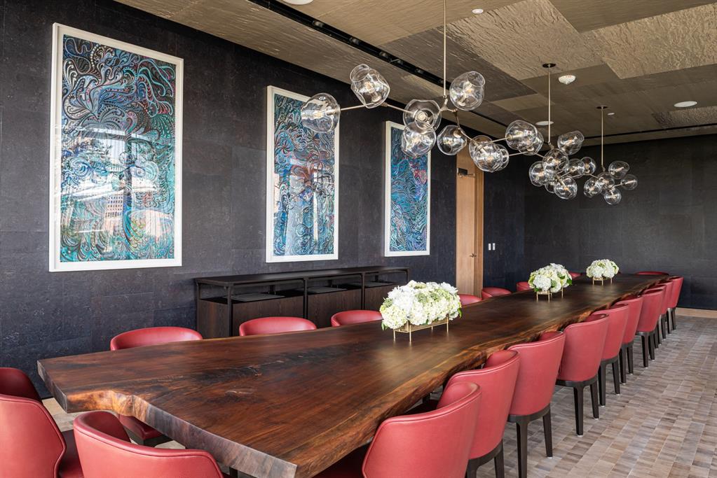 1747 Leonard Street, Unit 2402 Dallas, TX 75201 - Photo 26 of 35 a view of a dining room with furniture and chandelier