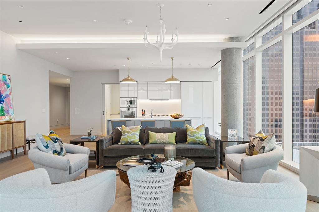 1747 Leonard Street, Unit 2402 Dallas, TX 75201 - Photo 5 of 35 a living room with furniture and a chandelier