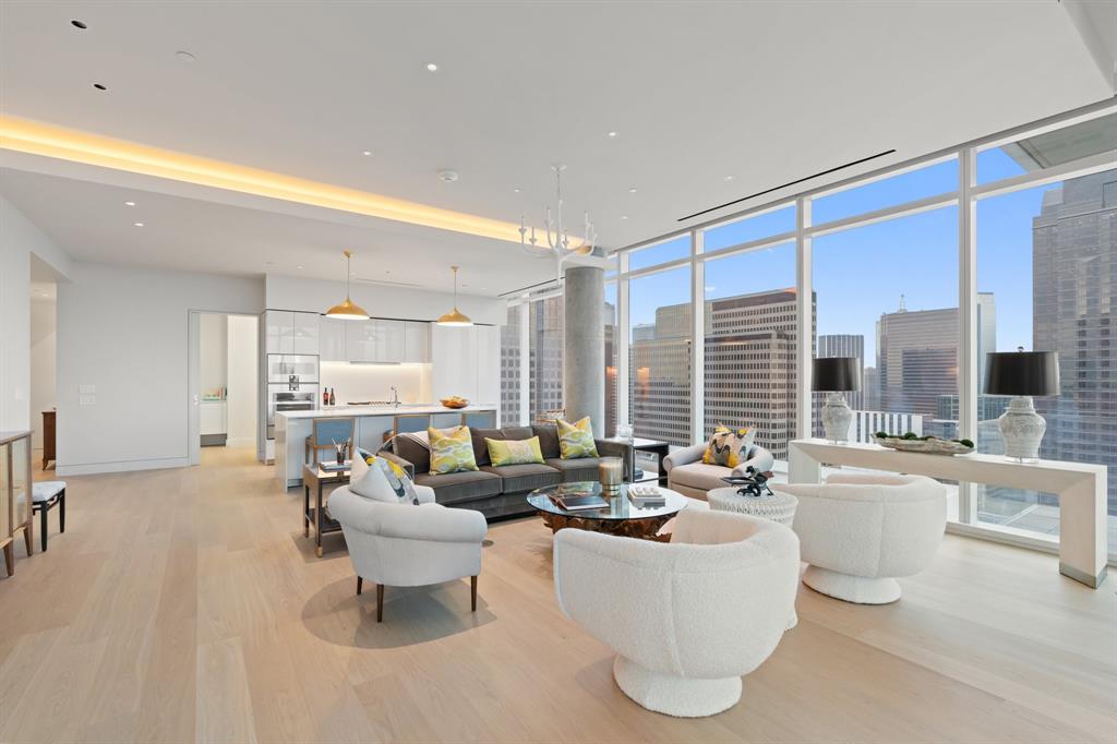 1747 Leonard Street, Unit 2402 Dallas, TX 75201 - Photo 7 of 35 a living room with furniture and large windows