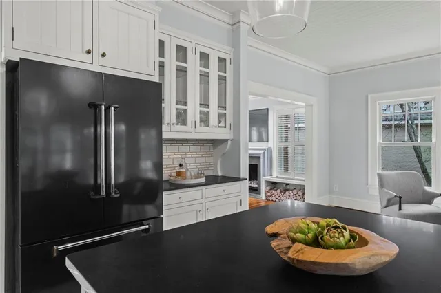 a kitchen with stainless steel appliances granite countertop a sink refrigerator and cabinets