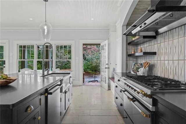 a kitchen with granite countertop a stove and a sink