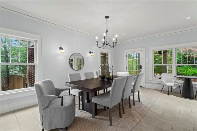 a dining room with furniture a chandelier and a rug