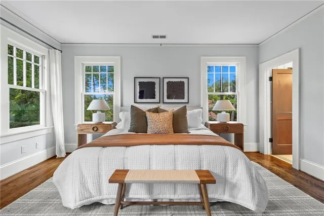 a bedroom with a bed and wooden floor
