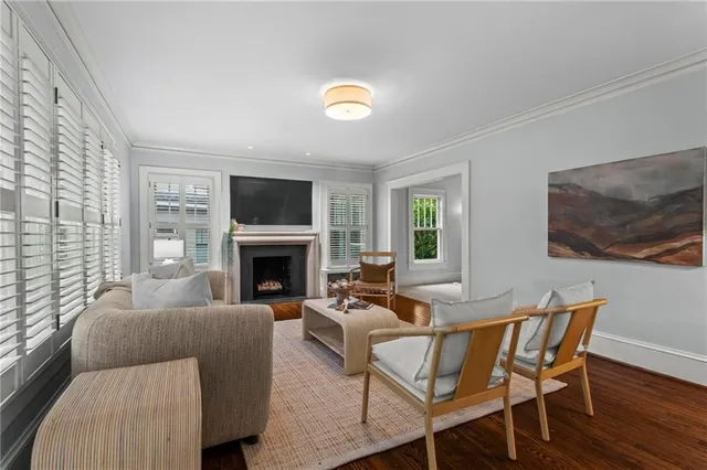 a living room with furniture a fireplace and a flat screen tv