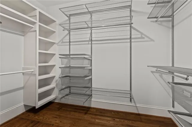 a view of walk in closet with empty racks